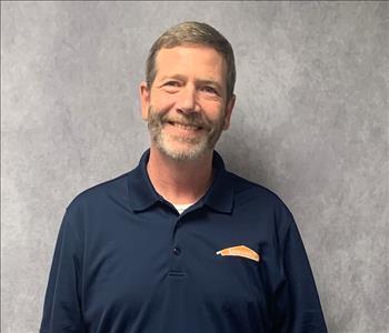 male posing in blue SERVPRO shirt, light beard