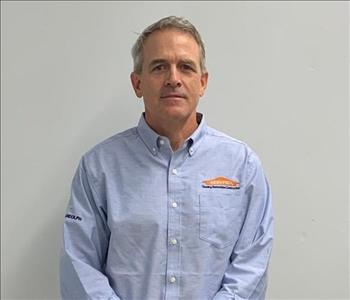 male posing in blue servpro shirt