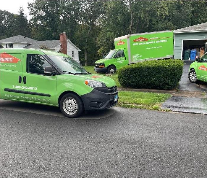 SERVPRO vehicles in driveway of home, ready to restore damage
