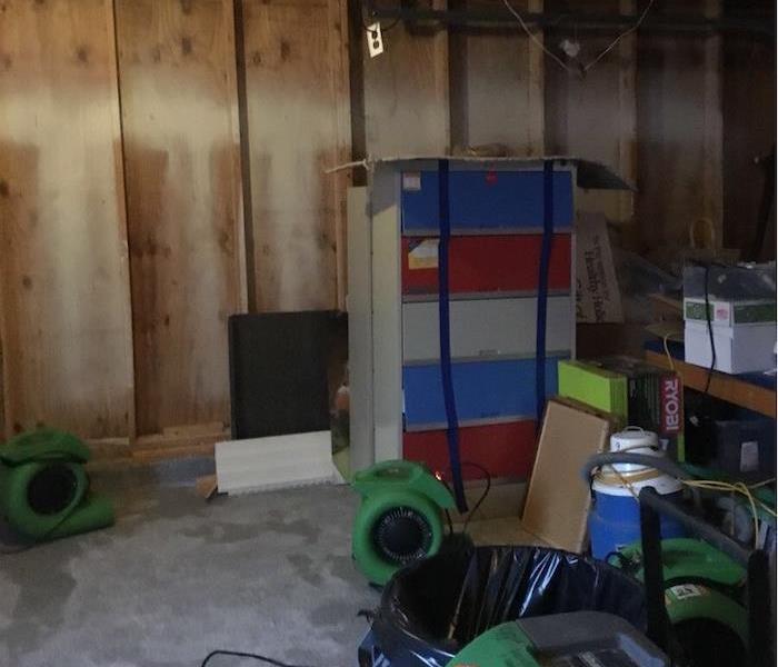 Garage with framework showing and items in the middle of the floor