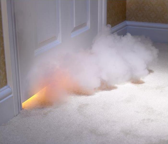 smoke coming entering room from under door; flame seen under door