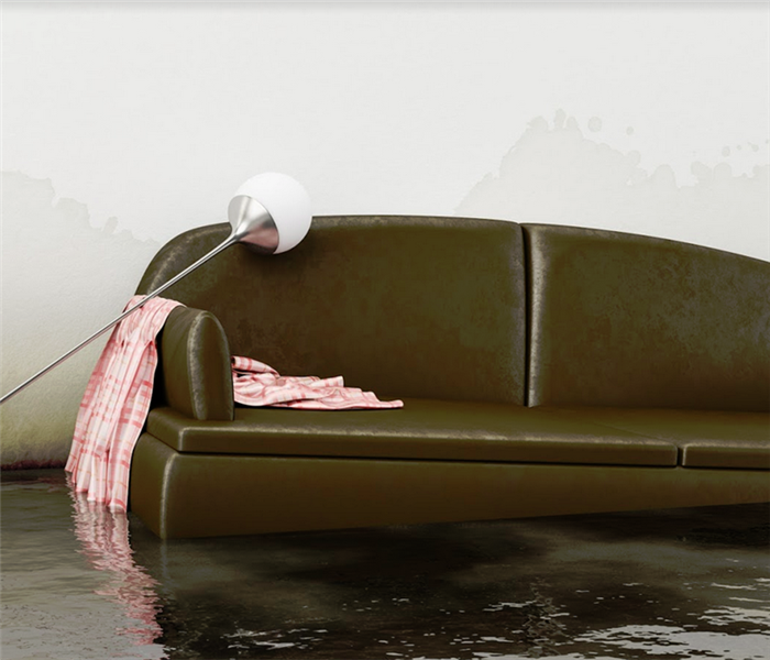 brown sofa floating in a flooded living room