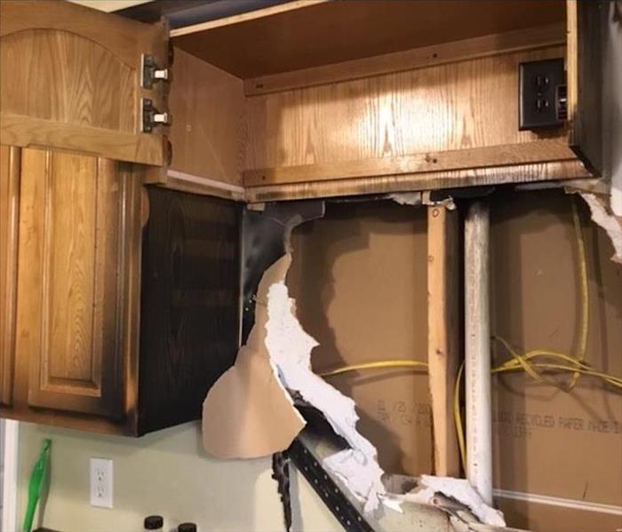 Kitchen cabinet with fire damage.