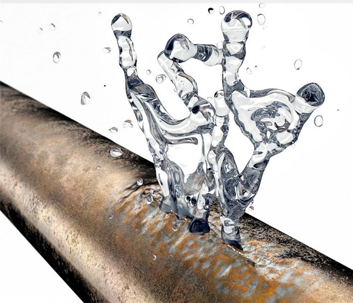 a broken copper pipe with water leaking from it