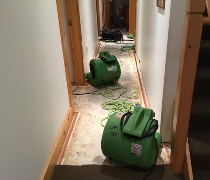 Several air movers in a hallway closet drying it out.