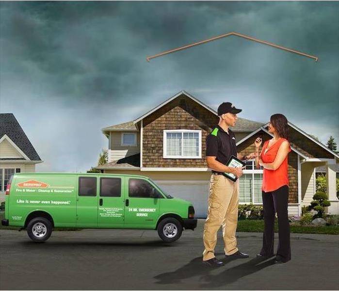 SERVPRO technician consulting with customer